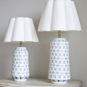Blue criss cross toleware lamp bases with plain Ottilie scalloped lampshades.