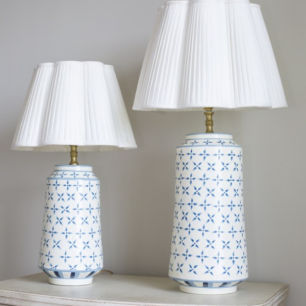 Blue criss cross toleware lamp bases with plain Ottilie scalloped lampshades.