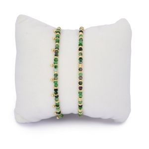 Serenity Ruby Zoisite & Gold Bracelet Stack featuring two gemstone bracelets with faceted ruby zoisite beads, one with aura bead accents and gold slider chains.