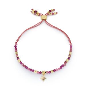 Una Ruby Mix Gold Star Charm Bracelet featuring ruby gemstone beads, a gold star charm with a pink crystal centre, and a gold-plated adjustable thread slider.