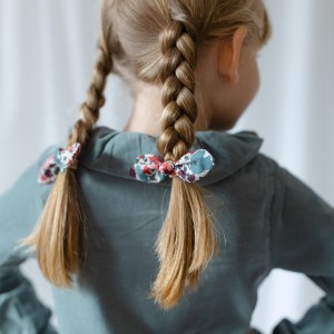 little girl with plaits and liberty hair bobbles