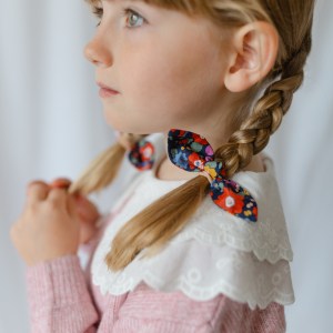 little girl with long plaits and liberty hair bobbles