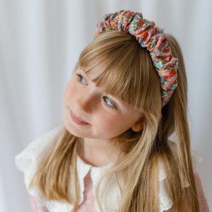 girl in white collered blouse and hairband